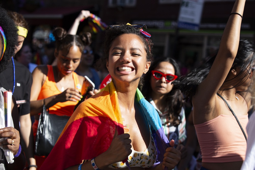 A smiling person at a LGBTQ Pride parade