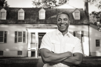 African American man in front of a house