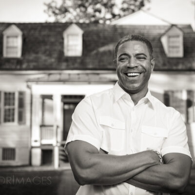 African American man in front of a house