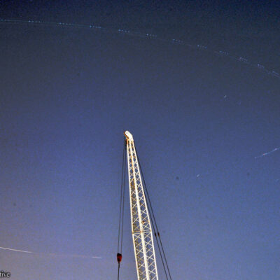 Image of plane circling in sky over radio tower