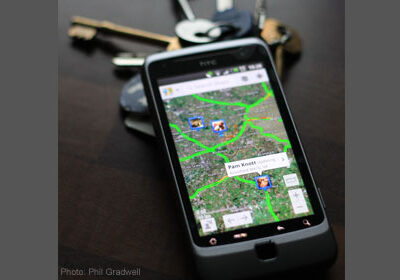 Image of a cell-phone displaying location information on a map.