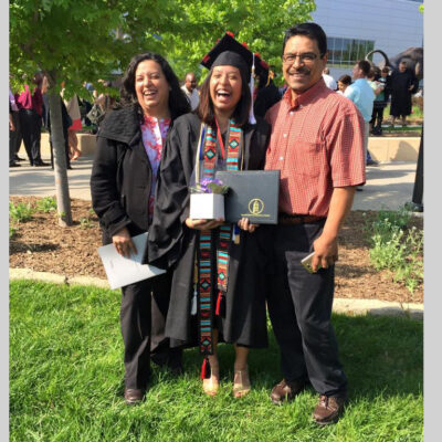 Maria Marquez Hernandez with her parents at her graduation
