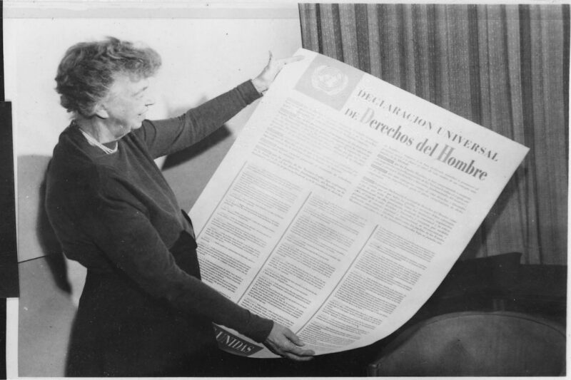 Eleanor Roosevelt holds a copy of the Spanish-language version of the Universal Declaration of Human Rights.