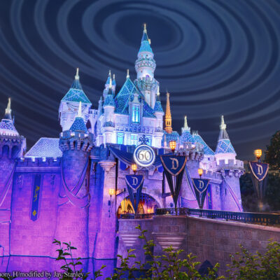 Disneyland castle at night with radio waves in sky above it