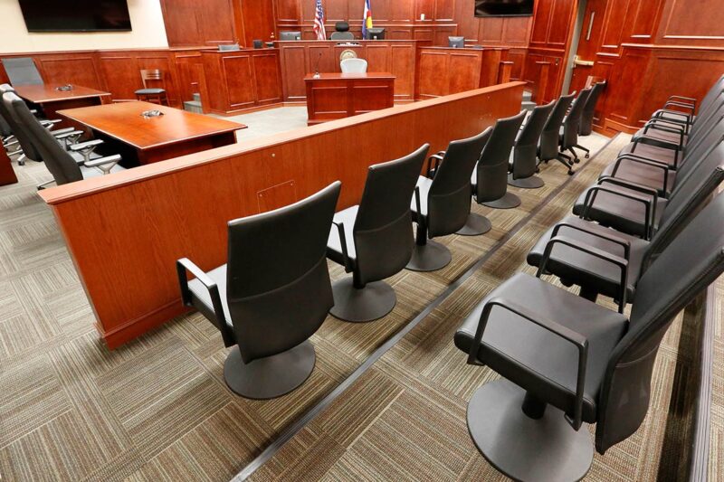 Image of an empty jury box in a courtroom