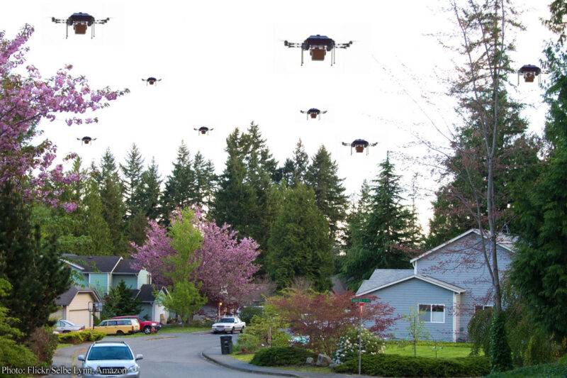 Neighborhood street with drones filling sky