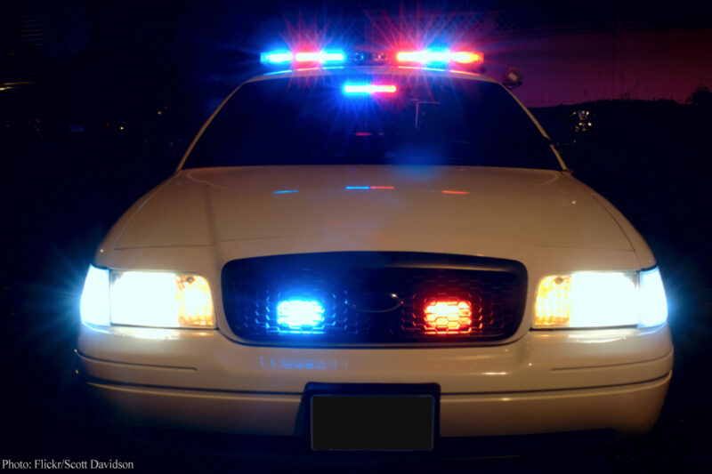 Front of police car with lights at night
