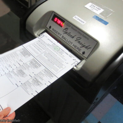 Ballot being fed into voting machine