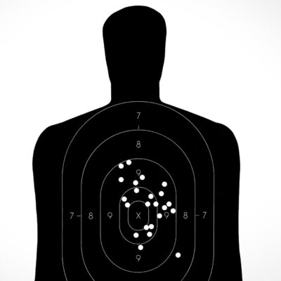 Person-shaped target with bullet holes
