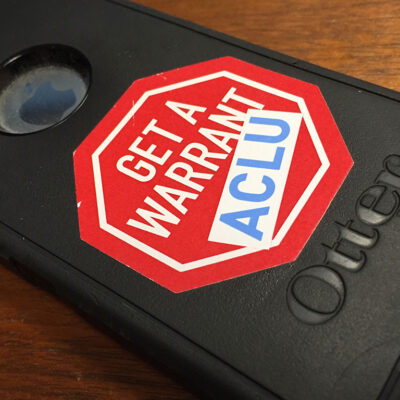 iPhone with "Get a Warrant - ACLU" sticker