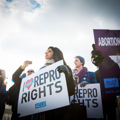 Protesters at an abortion rally holding signs