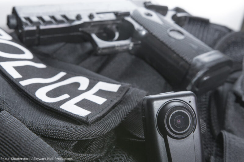 Police vest, body camera, and gun