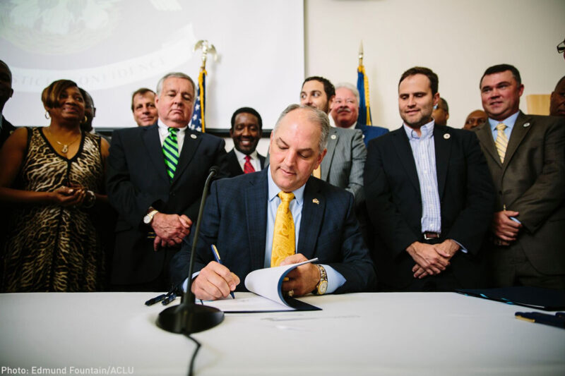 Gov. Edwards signs historic justice reinvestment legislation in a room full of advocates.