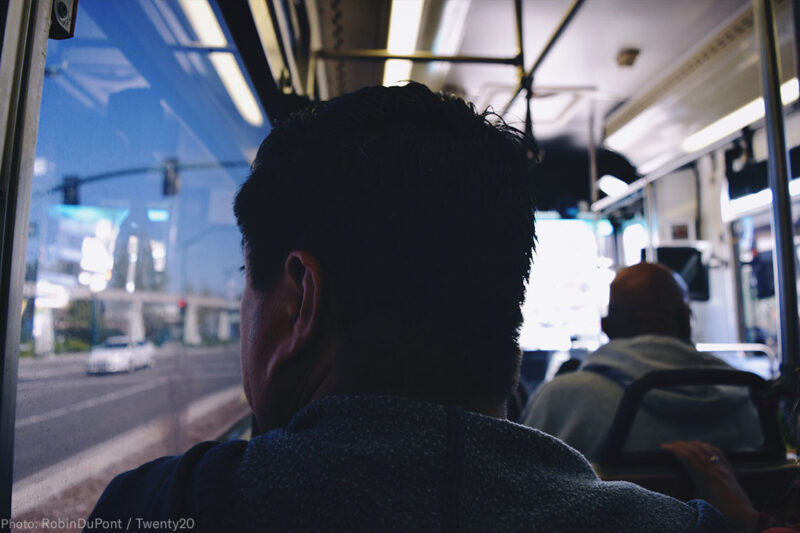 Man Looking Out Bus Window