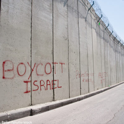 Graffiti on the Israeli separation wall dividing the East Jerusalem neighborhood of Abu Dis reads, "Boycott Israel"