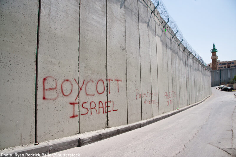 Graffiti on the Israeli separation wall dividing the East Jerusalem neighborhood of Abu Dis reads, "Boycott Israel"