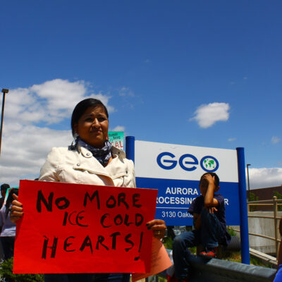 Protester in front of GeoGroup offices