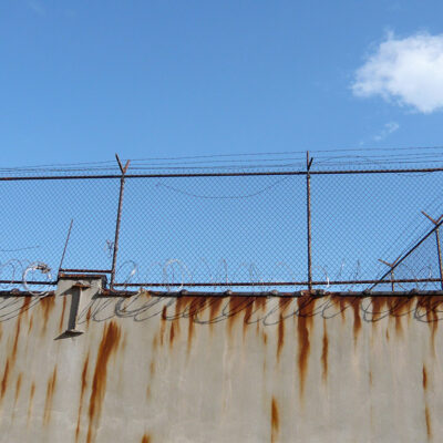 Barbed wire fence outside prison