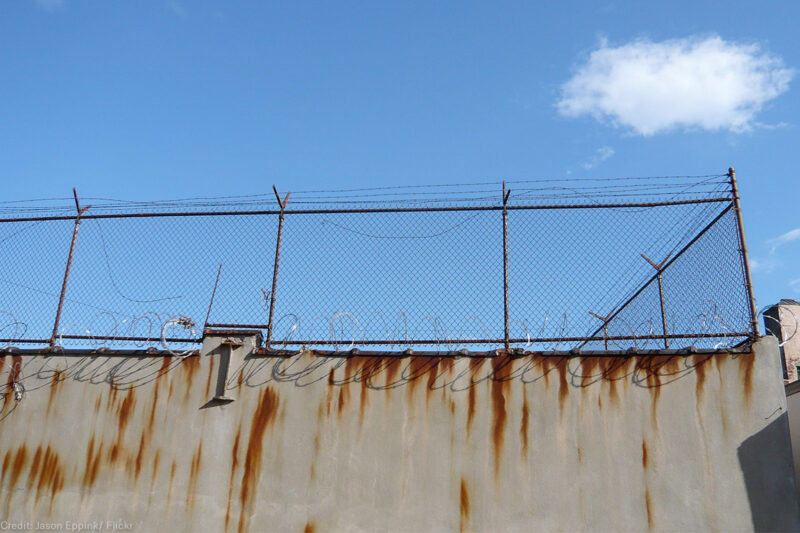 Barbed wire fence outside prison