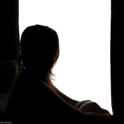 Silhouette of a woman by a window