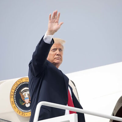 President Trump waving while boarding Air Force One