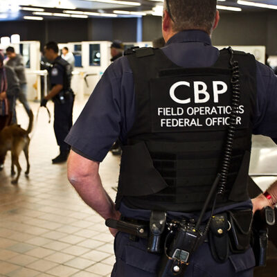 CBP officer watching pedestrian entrance