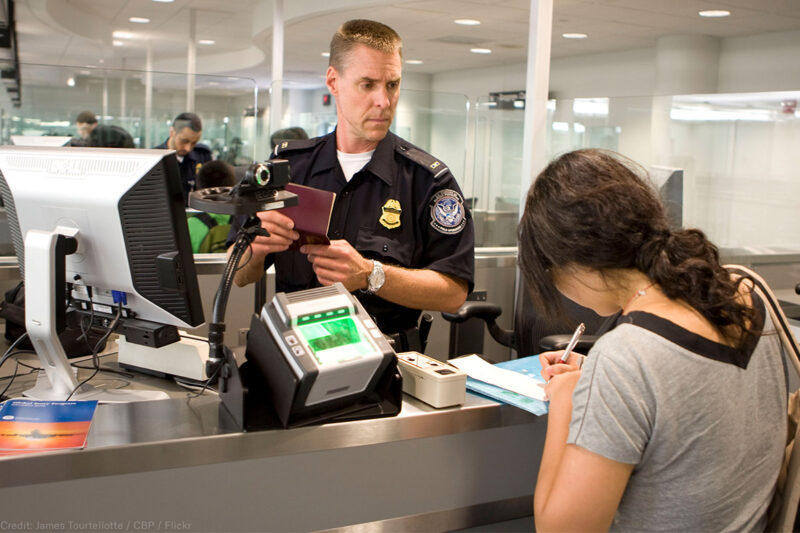 CBP Officer processes a passenger into the United States at an airport