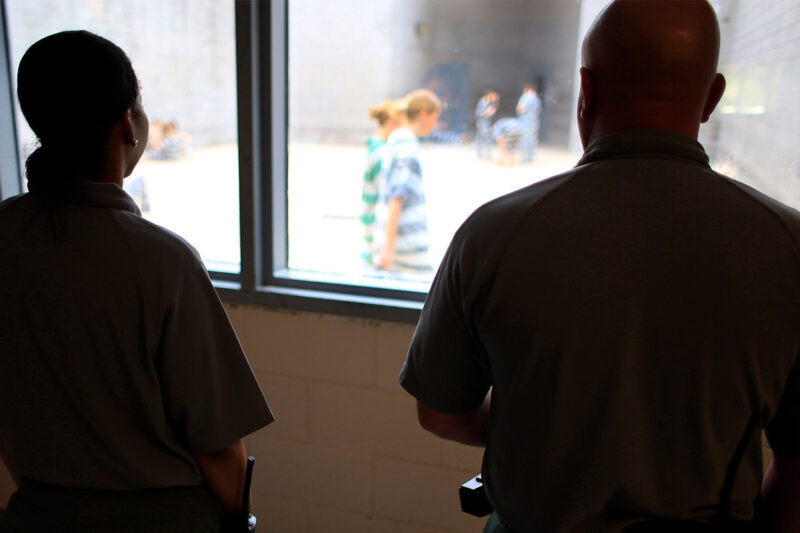 Deputies observe incarcerated people at in a women's detention area