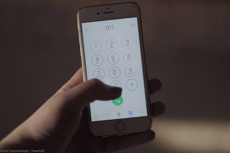Close up of a hand dialing 911 on a cell phone