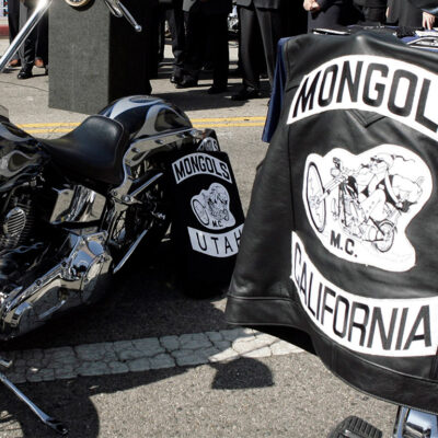 Mongols Motorcycle Club vests draped over motorcycles