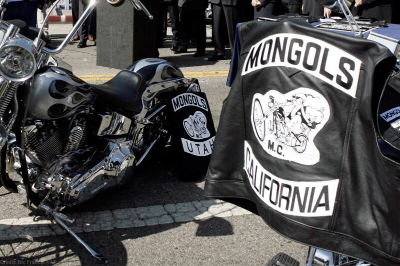 Mongols Motorcycle Club vests draped over motorcycles