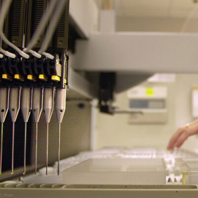 A technician loads patient samples into a machine for testing at Myriad Genetics