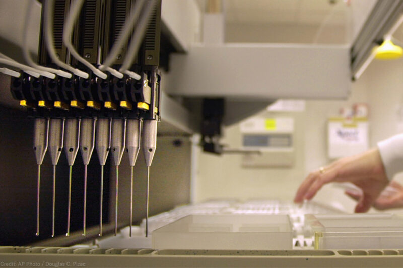 A technician loads patient samples into a machine for testing at Myriad Genetics