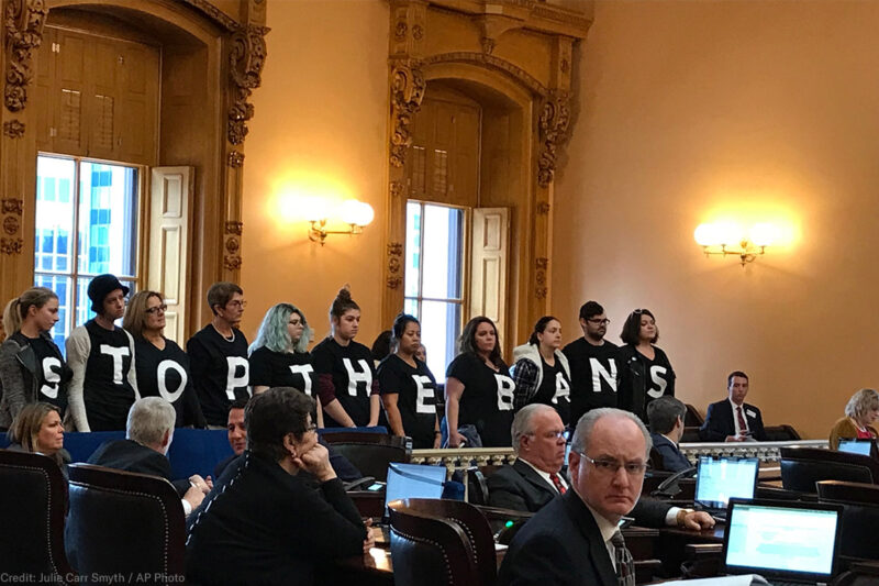 Pro-choice activists stand in protest in the Ohio Senate chamber