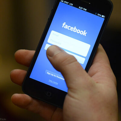 Smart phone in hand with Facebook app