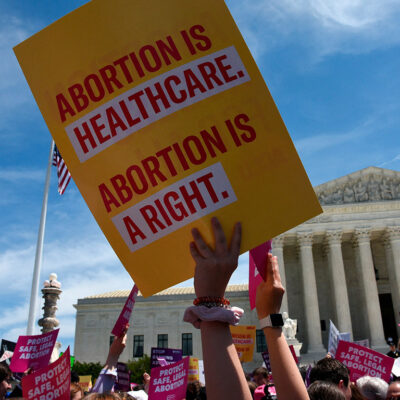 Protesters holding signs at abortion rally in front of Supreme Court