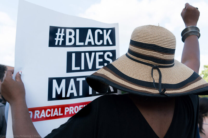 A protester holding a Black Lives Matter sign