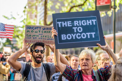 Protesters marching with signs in favor of the right to boycott