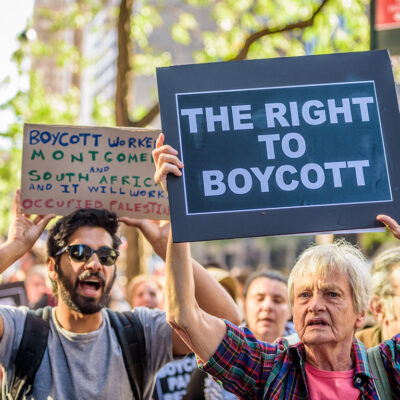Protesters marching with signs in favor of the right to boycott