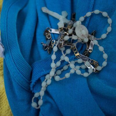 A rosary on a blue shirt
