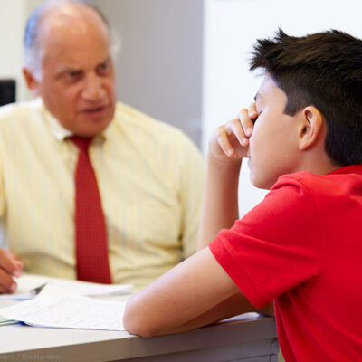 Distressed student sitting with a counselor