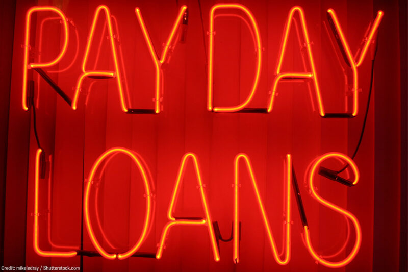 A neon sign with the text "payday loans"