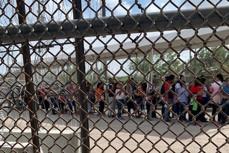 Families at the border through fence