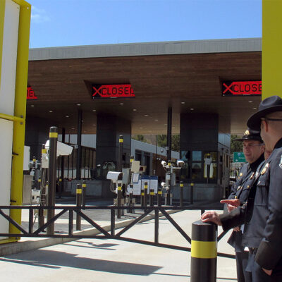 U.S. Customs and Border Protection officials stand at a border crossing facility on the U.S.-Canadian border