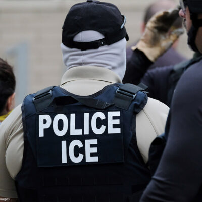 Back of an Immigrations and Customs Enforcement (ICE) officer's vest that reads "POLICE ICE." Taken in Portland, OR.