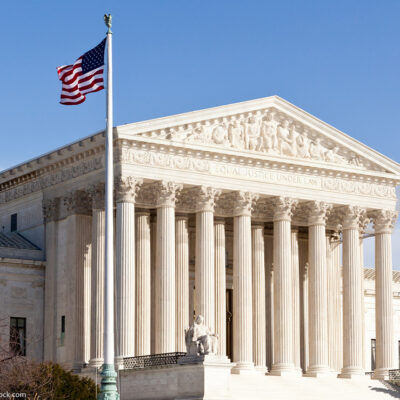 The front of the Supreme Court building in Washington DC on a sunny day.