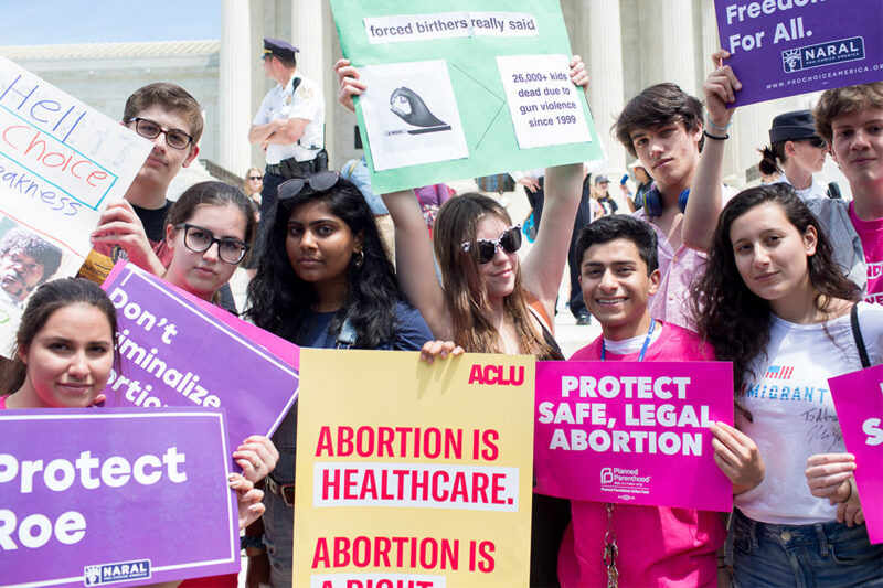 Pro-choice demonstrators with signs advocating the protection of the right to a safe abortion and that abortion is healthcare.