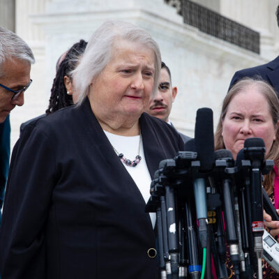 Aimee Stephens speaks with reporters outside the Supreme Court.