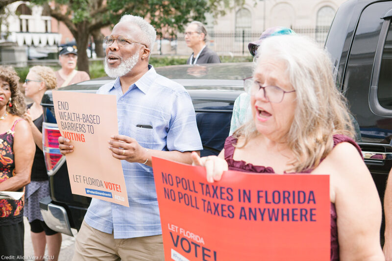 Protestors holding signs that read "no poll taxes in Florida"