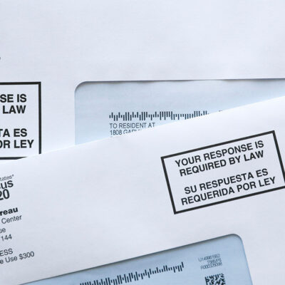 Two envelopes containing 2020 U.S. Census forms.